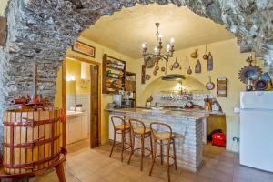 a kitchen with a bar with stools in it at Su Cuccumeu 