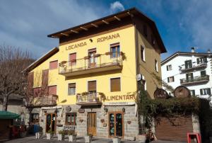a yellow building with two balconies on it at Locanda Romana in Fanano