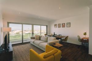 a living room with a couch and a table at Best Houses 74 - SurfSide Lodge in Peniche