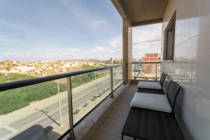 a balcony with two chairs and a view of a highway at Best Houses 74 - SurfSide Lodge in Peniche