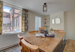 a dining room with a wooden table and chairs at James Cottage in Southwold
