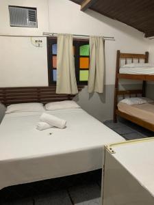 En eller flere senger på et rom på Pousada Travessia