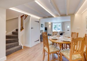 a dining room with a table and chairs at Japonica Cottage in Wenhaston