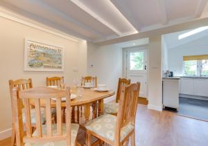 a kitchen and dining room with a table and chairs at Japonica Cottage in Wenhaston