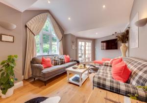 a living room with two couches and a table at Ivy Lodge in Rendlesham