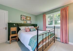 a bedroom with a bed and a window at Ivy Lodge in Rendlesham