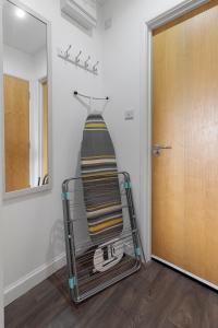 a towel on a towel rack next to a door at Exeter City Centre Apartments Stoop Apartment in Exeter