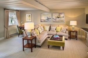 a living room with a couch and a table at Foxhills Club & Resort in Chertsey