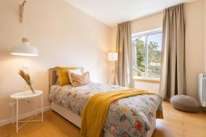 a bedroom with a bed and a window at Marachique Villa - Torralvor in Alvor +73 photos