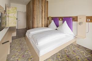 Postel nebo postele na pokoji v ubytování Explorer Hotel Montafon