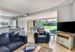 a living room with a couch and a tv at Loxwood in Reydon