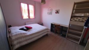a small bedroom with a bed and a desk at 13Tours in Tours