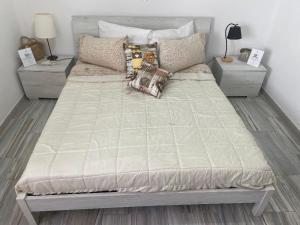 a large bed in a bedroom with two night stands at B&B Thérèse 13 in Ginosa Marina