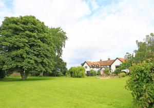 a large yard with a house and a tree at Kings Farm in Wangford