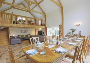 a dining room with a table and chairs and a living room at Kings Farm in Wangford
