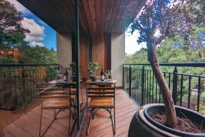 a patio with tables and chairs on a balcony at The Bells - Luxury Serviced Apartments in Leeds