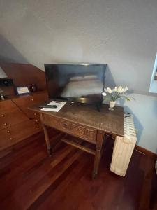 a wooden desk with a computer on top of it at Bed & Breakfast Chez Berry in Aosta
