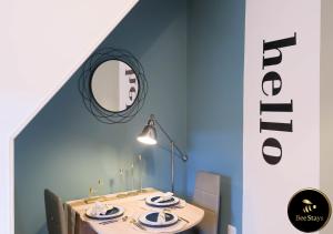 a dining room with a table and a mirror at Bee Stays - Cooper House in Haydock