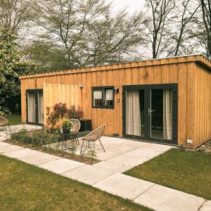 ein kleines Holzhaus mit einem Tisch und Stühlen in der Unterkunft B&B Schoonhoven Suites in Elim