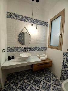 a bathroom with a sink and a mirror at Ca Sà Bellò San Vito Lo Capo in San Vito lo Capo +27 photos