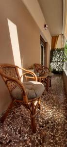 a group of chairs sitting in a hallway at Casa bonita in the center of Volos in Volos