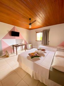 a bedroom with a large bed with a wooden ceiling at Topo do Cipó Ecopousada Vegana in Serra do Cipo +163 photos