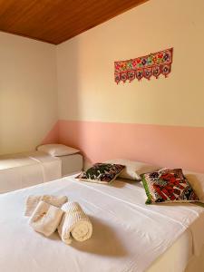 a bedroom with two beds with pillows on them at Topo do Cipó Ecopousada Vegana in Serra do Cipo