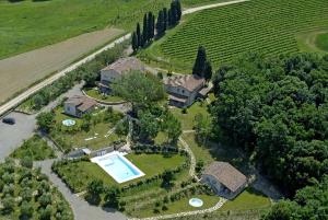 an aerial view of a house with a swimming pool at Borgo della Meliana Gambassi Terme in Gambassi Terme