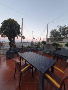 a picnic table and chairs on top of a patio at Hotel Mareluna Ischia in Ischia