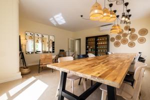 a dining room with a wooden table and chairs at Marachique Villa - Torralvor in Alvor