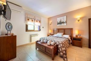 a bedroom with a bed and a television in it at Villa Cas Pla 33 in Sant Joan de Labritja