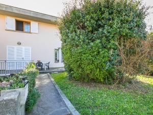 a large green bush in front of a house at Apartment Angela by Interhome in Rosignano Solvay