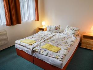 a bedroom with a bed with two towels on it at Holiday Home Chata Labaika by Interhome in Harrachov