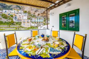 a table with food and a view of positano at Positano Dream Home in Positano