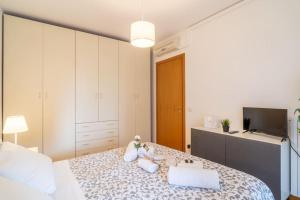 a bedroom with a bed with pillows and a television at Charme in Porta Palio - City Center in Verona