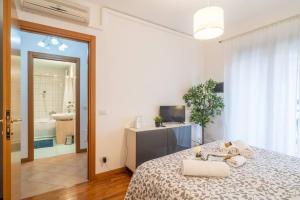 a bedroom with a bed and a bathroom with a tub at Charme in Porta Palio - City Center in Verona