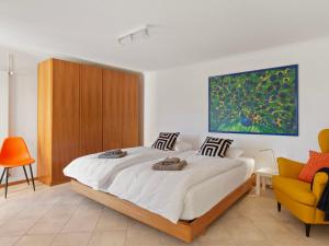 1 dormitorio con 1 cama y una pintura en la pared en Apartment Vista Isole di Brissago by Interhome, en Ronco sopra Ascona