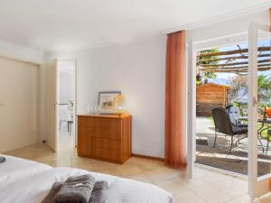 a bedroom with a bed and a sliding glass door at Apartment Vista Isole di Brissago by Interhome in Ronco sopra Ascona