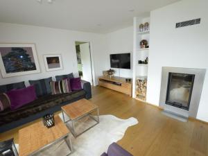 un soggiorno con divano e camino di Apartment Uehlinger Züger by Interhome a Valbella