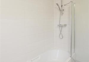 a shower with a glass door in a bathroom at Millers Cottage in Woodbridge