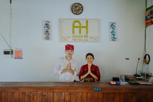 a man and a woman doing yoga in a room at Abasan Hill Hotel and Spa in Nusa Penida