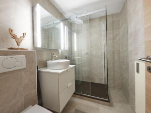 a bathroom with a sink and a shower at Apartment Les Mélèzes by Interhome in Les Collons