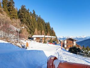 a snow covered ski slope with a ski lodge at Apartment Les Mélèzes by Interhome in Les Collons