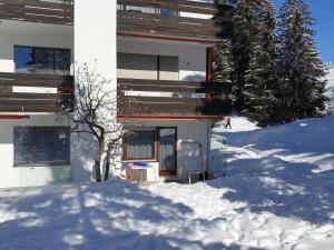 a building with snow in front of it at Apartment Uehlinger Seegarten Wirz by Interhome in Lenzerheide