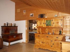 a kitchen with wooden cabinets and a table at Apartment Ferienwohnung Haltenboden by Interhome 