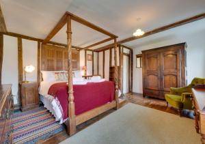 a bedroom with a canopy bed in a room at Old Brewery House in Orford
