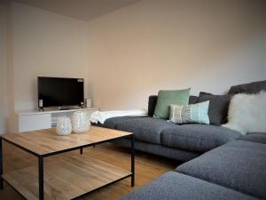 a living room with a couch and a coffee table at Apartment Uehlinger Rosana by Interhome in Lenzerheide