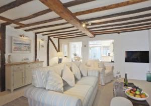 a living room with a couch and a table at Oyster Cottage in Southwold