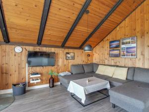 a living room with a couch and a table at Holiday Home Agnesa - 1-5km from the sea in Western Jutland by Interhome in Vejers Strand