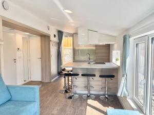 a kitchen with a counter and stools in a room at Holiday Home Sky-Chalet by Interhome in Imst +50 photos